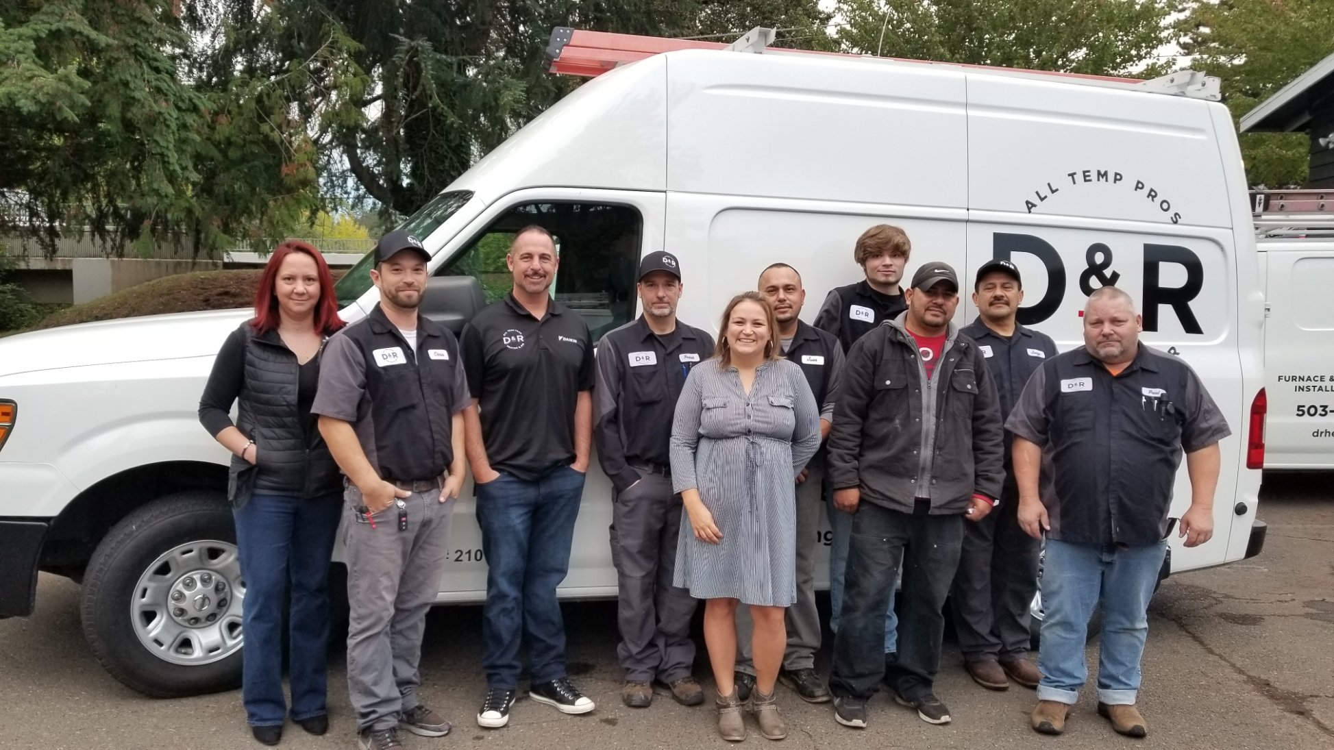 D and R team standing in front of work van